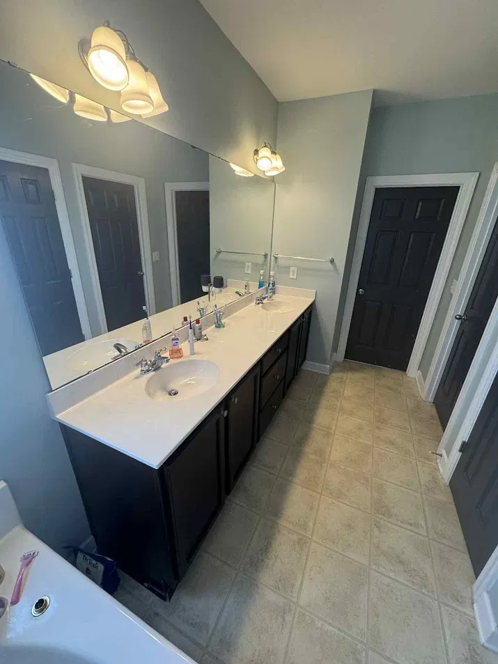 Before: Dated bathroom with old vanity and basic tile before CNB Renovations